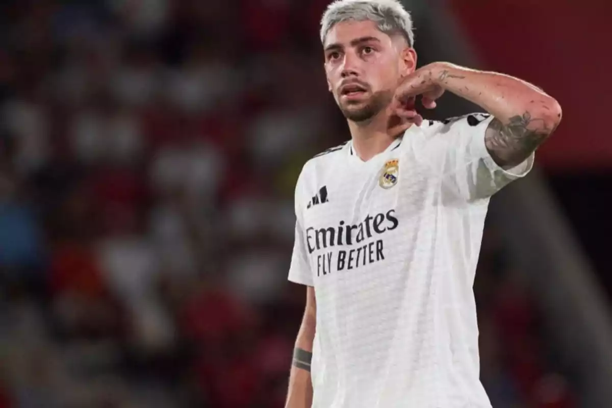 A soccer player in a white Real Madrid jersey on the field. A soccer player in a white Real Madrid jersey on the field.