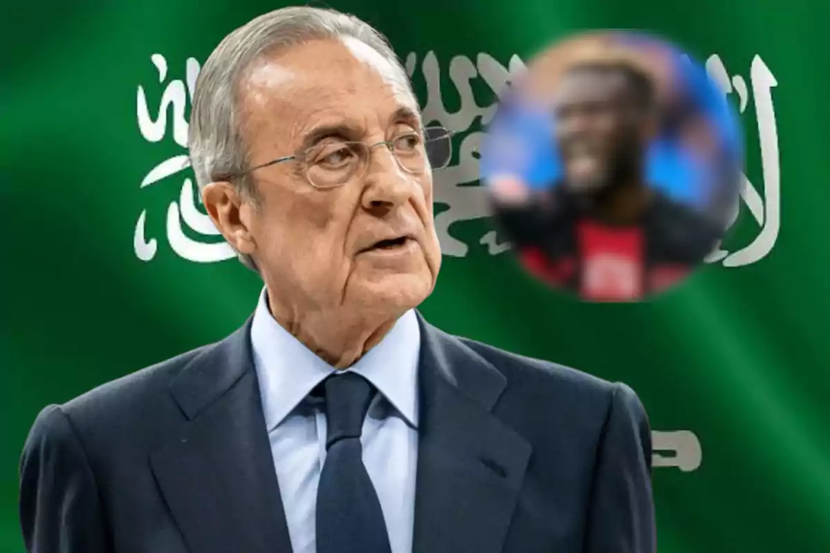 An older man wearing glasses and a dark suit stands in front of a green flag with Arabic writing on it, and there is a blurred circle with the image of another person in the upper right corner.