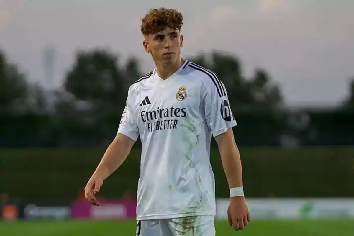 A player in a white uniform on the playing field.