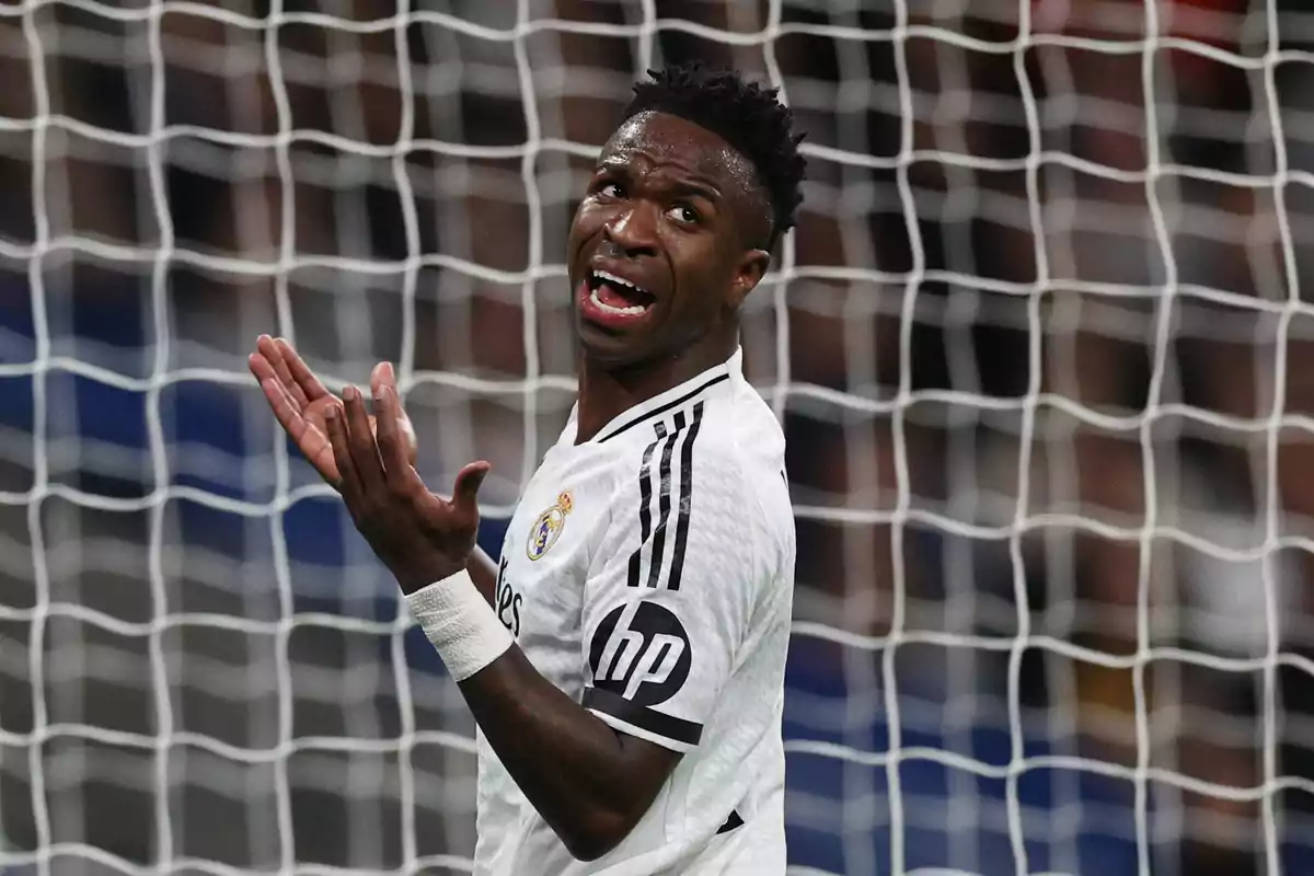 A player with a frustrated expression on the field, wearing his team's white uniform, with a goal net in the background. A player with a frustrated expression on the field, wearing his team's white uniform, with a goal net in the background.