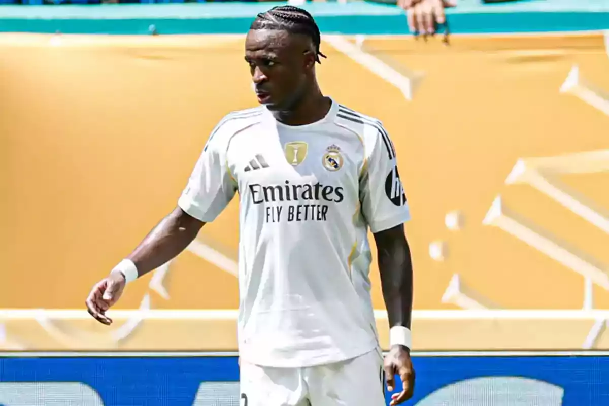 Soccer player wearing Real Madrid’s white uniform on the field during a match Soccer player wearing Real Madrid’s white uniform on the field during a match