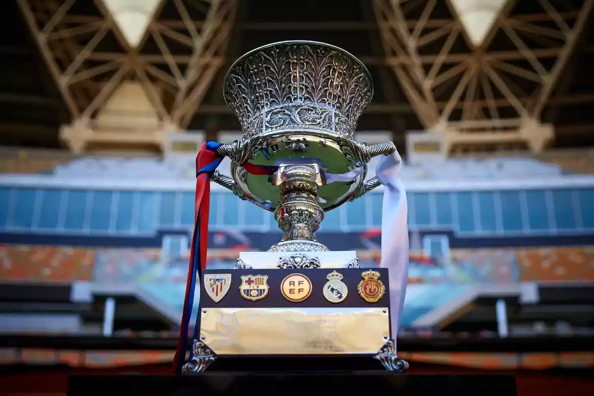 Football trophy with ornamental details and colored ribbons in a stadium.