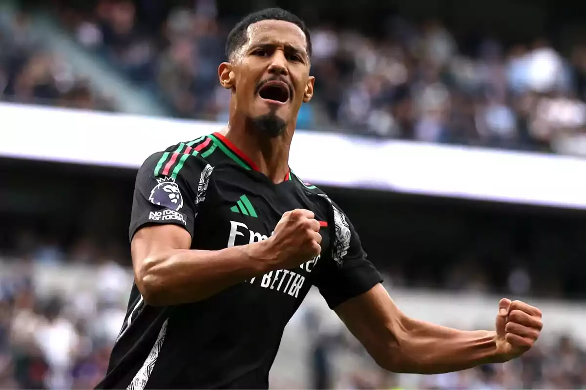 A soccer player celebrates with a clenched fist and an expression of excitement on the field. A soccer player celebrates with a clenched fist and an expression of excitement on the field.
