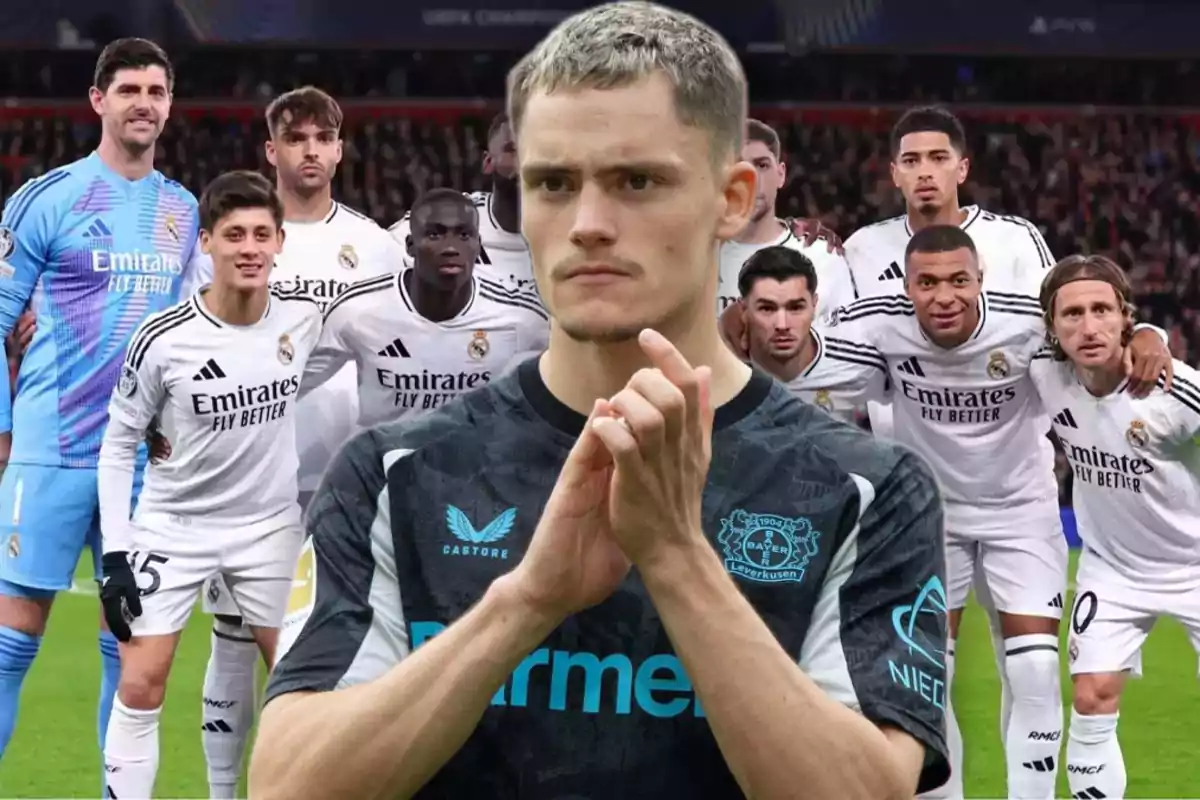 A Bayer Leverkusen player appears in the foreground while the Real Madrid team can be seen in the background posing for a group photo on the soccer field.