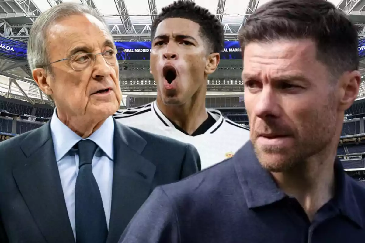 Three men in a soccer stadium, one of them wearing a white jersey, another in a suit, and the third in a dark jersey.