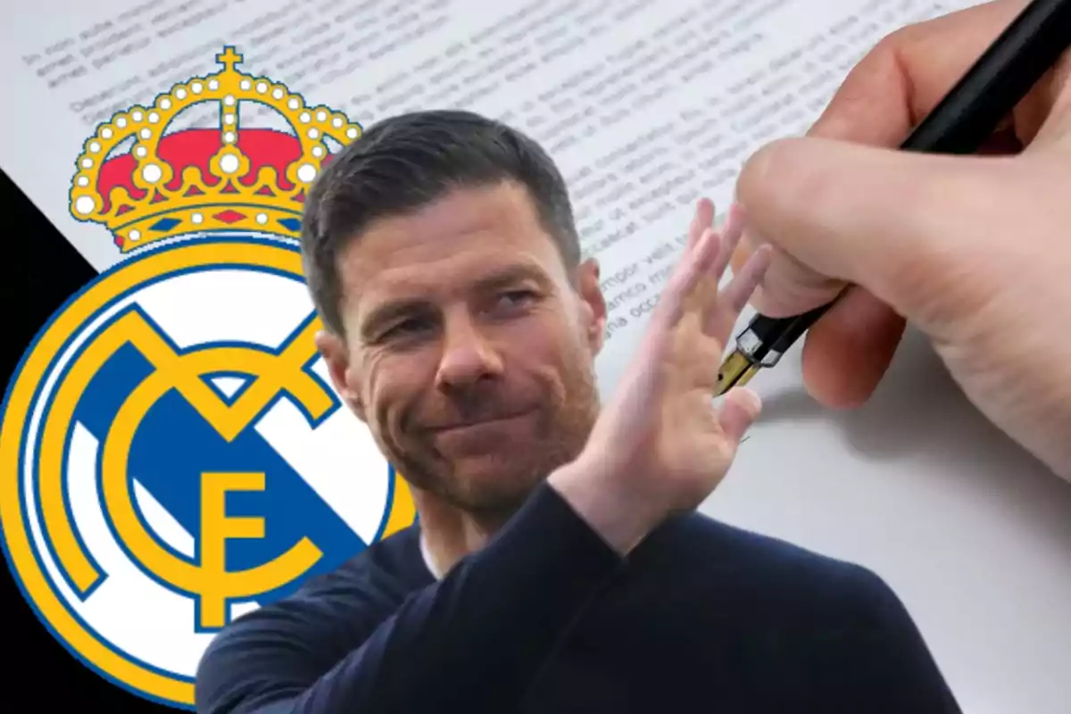 A smiling man raises his hand in front of a Real Madrid logo while a hand holds a pen over a document.