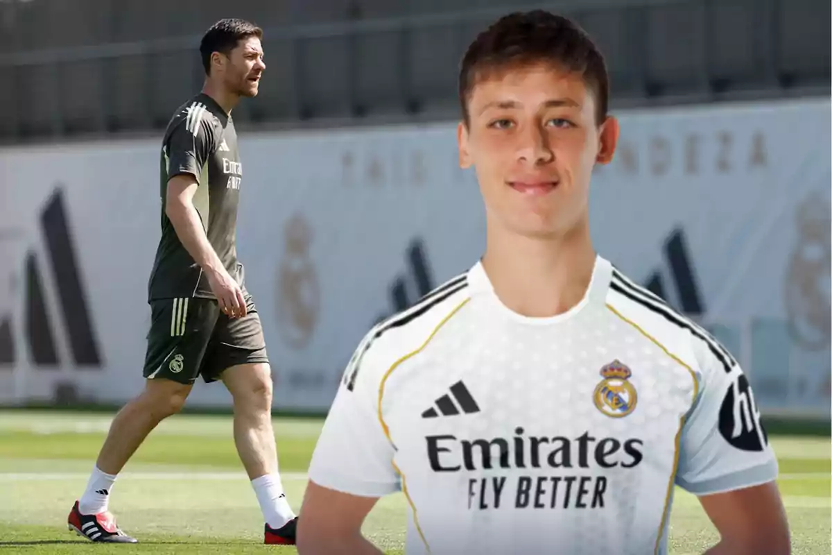 Soccer coach in training uniform walking on a field and a young player wearing a white Real Madrid jersey in the foreground