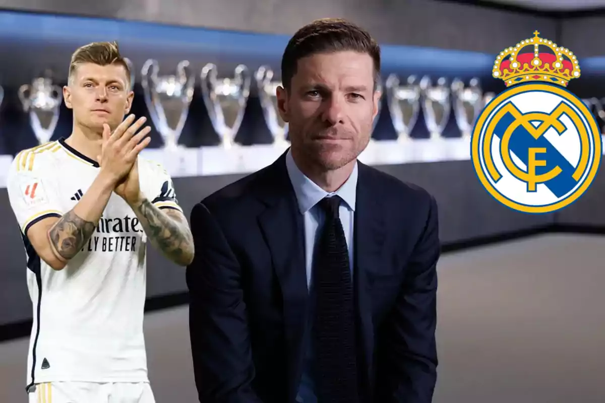 A Real Madrid player applauds alongside a man in a suit and the club’s crest, with several trophies in the background.