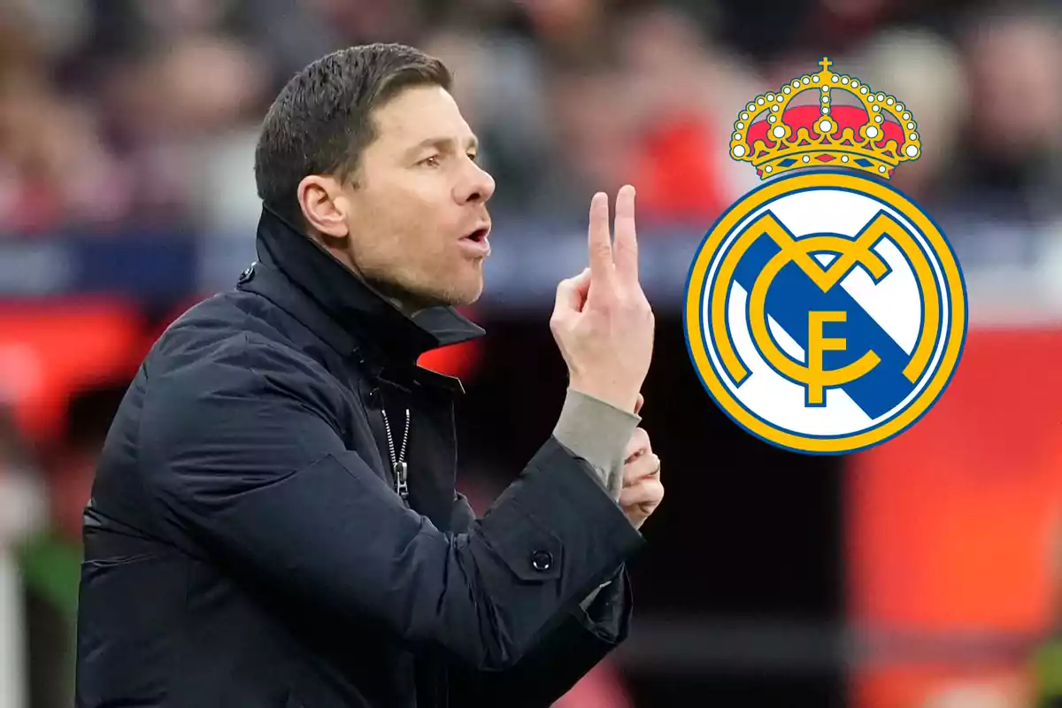 A man in a dark jacket gestures with his hand as the Real Madrid logo appears next to him.