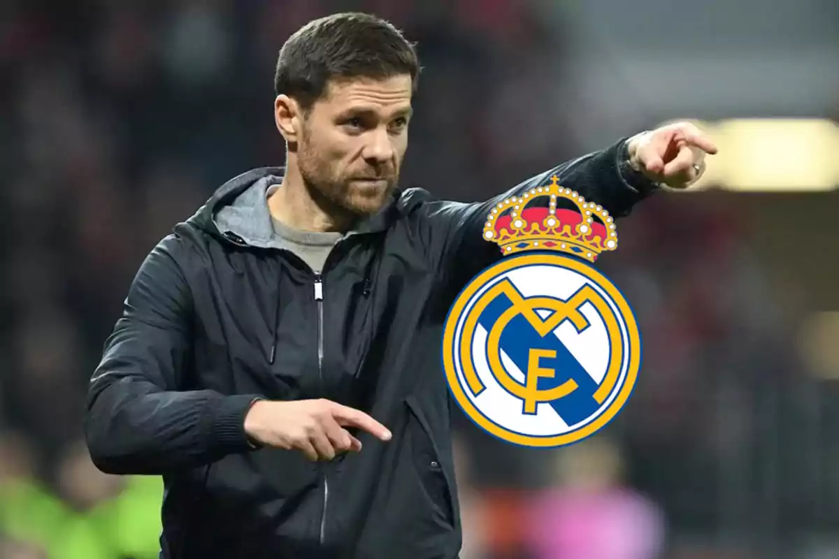 A man in a black jacket pointing forward with the Real Madrid crest overlaid.