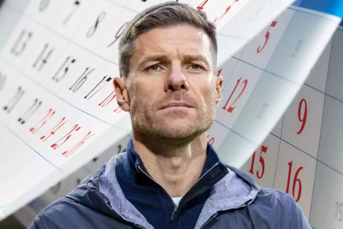 Short-haired man with a serious expression in the foreground with a blurred calendar in the background