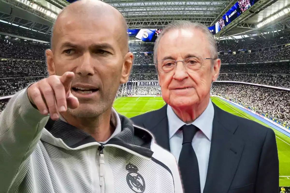 Dos hombres en un estadio de fútbol lleno, uno de ellos con chaqueta deportiva del Real Madrid señalando hacia el frente y el otro con traje y corbata